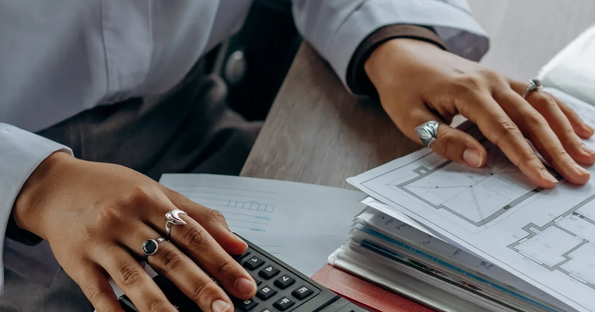 A person calculating with financial documents